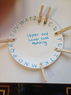 a paper plate with clothes pins attached to it that says upper and lower case matching