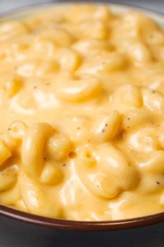 a bowl filled with macaroni and cheese on top of a table