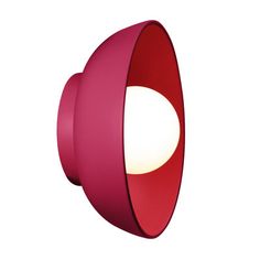 a red light that is on top of a white wall mounted fixture with a round lens