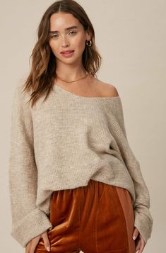 So chic and effortless, this slouchy, oversized tunic-style sweater features a v-neckline and dropped wide sleeves for added shape. -Available in Stone & Misty Blue -Waffle textured -V-neck -Oversized fit -Soft touch eyelash two tone yarn -Long sleeve with folded cuffs -Side slits -Ribbed on hem -Content: 74% Acrylic 22% Polyester 4% Lycra -Hand was cold/Line dry -Imported -Model is 5 8" 32-24-34 and wearing a size Small Soft Knit V-neck Top, Oversized Chic V-neck Sweater, Oversized V-neck Sweater For Loungewear, Trendy Oversized V-neck Sweater For Loungewear, Oversized V-neck Chic Sweater, Oversized V-neck Sweater For Layering, Chic Oversized Knit Top For Fall, Oversized Chic V-neck Sweater For Layering, Chic Oversized V-neck Sweater For Layering