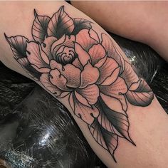 a black and white flower tattoo on the leg