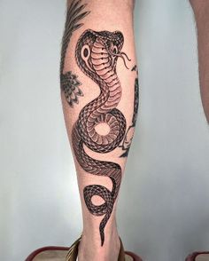 a man's leg with a tattoo on it and a snake in the middle