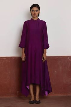 Purple dress with asymmetrical hem. Comes with purple Banarasi brocade jacket with woven floral patterns. - Aza Fashions Purple Silk Kurta For Party, Chic Dresses With Traditional Drape For Festive Occasions, Chic Silk Festive Dress, Festive Chic Dress With Traditional Drape, Fitted Silk Purple Kurta, Purple Anarkali Dress With Long Sleeves, Purple Long Sleeve Anarkali Dress, Elegant Fitted Purple Kurta, Long Sleeve Silk Dresses For Occasions