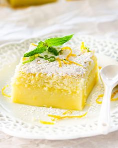 a slice of lemon cake on a plate with a spoon