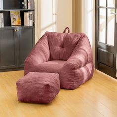 a pink bean bag chair and ottoman in a living room