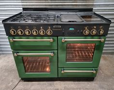 an old green stove with two ovens on the front and one in the back