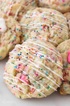 several cookies with white icing and sprinkles