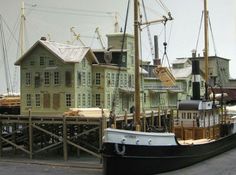 a boat that is sitting in the water next to a building with many windows on it