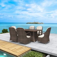 a table and chairs on a deck overlooking the ocean