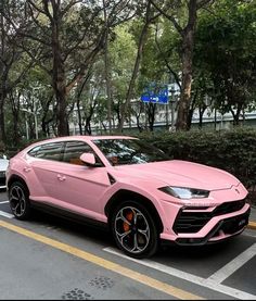 a pink lamb suv is parked on the street