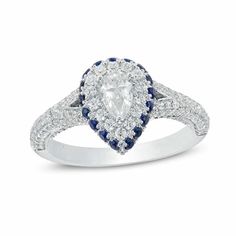 a pear shaped diamond ring with blue and white diamonds on the band, set in 18k white gold