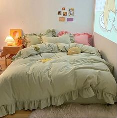 a bed room with a neatly made bed and a projector screen on the wall