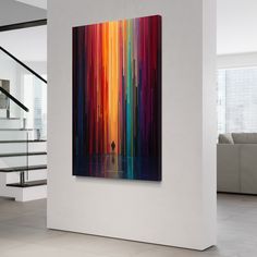 an abstract painting hangs on the wall next to stairs