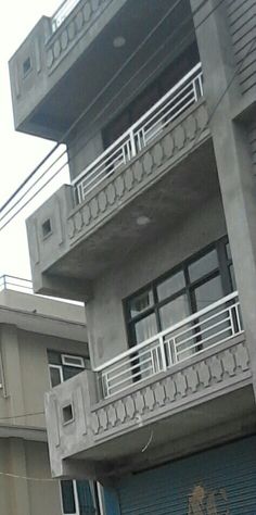 an apartment building with two garages and a fire hydrant