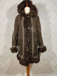 Sheepskin Long Fur Coat For Cold Weather, Sheepskin Long Coat For Cold Weather, Brown Fur Coat With Feather Trim, Brown Long Sleeve Fur Coat With Feather Trim, Hooded Brown Sheepskin Fur Coat, Winter Sheepskin Outerwear With Feather Trim, Bohemian Brown Fur Coat With Faux Fur Lining, Penny Lane Coat, Daisy Jones