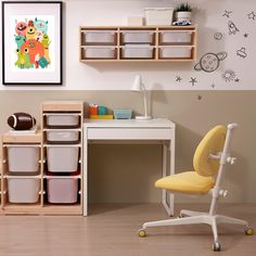 a child's desk and chair in a room with toy storage bins on the wall