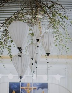 four white lanterns hanging from the ceiling