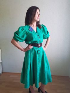 Amazing vintage Austrian dress with puffy sleeves and cute Embroidery, 58%linen, 42%baumwoole. It's elegant and comfortable. Is sold without a belt. Great condition, no holes or spots. ** Size L, maybe . Please see measurements: Model is size M and 170 cm growth. **This item will come to you freshly laundered and ready to wear. **If you want to purchase more items, please message me, I will make a special price and delivery. Vintage Linen Dress For Garden Party, Vintage Linen Dress For Spring, Spring Vintage Linen Dress, Vintage Linen Dress For Spring Daywear, Vintage Fitted Linen Dress For Garden Party, Fitted Vintage Linen Dress For Garden Party, Fitted Peasant Dress With Puff Sleeves For Daywear, Green Puff Sleeve Dress In Cottagecore Style, Vintage Green Puff Sleeve Dress