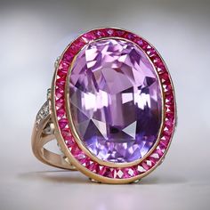 This beautiful ring showcases a stunning Kunzite ring gemstone weighing 24.10 carats. The Kunzite ring has a lovely pink color that stands out beautifully. The center stone is encircled by a touch of French-cut rubies, adding a touch of elegance. The gallery beneath the Kunzite is adorned with a delicate diamond lace pattern. Crafted in 18k yellow gold, this Kunzite ring is truly exquisite. With a total weight of approximately 1.20 carats, the rubies charm of the Kunzite ring also features appro Luxury Kunzite Engagement Ring, Luxury Kunzite Jewelry In Yellow Gold, Luxury Ruby Ring With Diamond Accents, Exquisite Amethyst Ring With Gemstone Accents For Formal Occasions, Luxury Sapphire Ring With Gemstone Accents For Formal Wear, Luxury Sapphire Ring With Gemstone Accents For Formal Occasions, Luxury Formal Sapphire Ring With Gemstone Accents, Luxury Ruby Ring With Gemstone Accents For Anniversary, Luxury Collectible Sapphire Ring