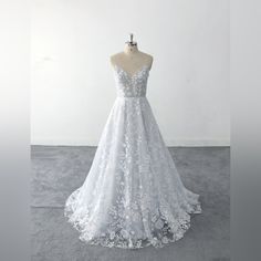 a white wedding dress on a mannequin in front of a white wall and floor