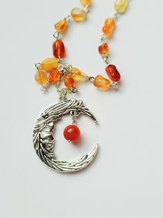 My new favorite necklace! I almost kept this one for myself... This necklace features a bright silver pendant and chain. Pendant is a feathered crescent moon with a woman's face. I paired this with varying shades of orange carnelian for a contrasting sun/moon color scheme Matching bracelet is 7 inches. I can adjust the necklace and bracelet length upon request. Moon Goddess Necklace, Orange Stone, Goddess Necklace, Carnelian Beads, Celestial Jewelry, Unusual Jewelry, Halloween Earrings, Moon Necklace, Matching Bracelets