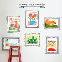 there are many pictures on the wall with children's artwork in them, and one has a red stool