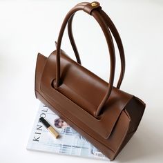 Luxury Brown Box Bag With Large Capacity, Luxury Large Capacity Brown Box Bag, Brown Satchel Shoulder Bag For Daily Use, Chic Brown Handheld Box Bag, Brown Box Shoulder Bag For Office, Brown Top Handle Box Bag For Everyday, Brown Satchel Shoulder Bag With Removable Pouch, Modern Brown Shoulder Bag With Detachable Handle, Everyday Brown Top Handle Box Bag