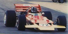 a man driving a racing car down a race track