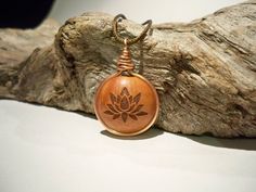 Made to order (small differences in wood texture and color may occur) This unique necklace pendant is made out of solid piece of briar wood and is rounded with copper wire ring. The symbol is laser engraved but all of my products, as well as this one, are handmade. Treated and polished with linseed oil and shellac it will last you a long time. Even though the wood itself is quite resistant, it benefits from certain amount of care and attention, so, if you can, polish it from time to time with na Copper Wire Ring, Lotus Pendant, Unique Pendant Necklace, Adjustable Knot, Engraved Pendant, Wire Ring, Copper Ring, Wood Necklace, Wire Rings