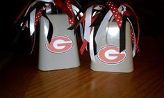 two ceramic jugs decorated with red, white and black ribbons on a wooden table