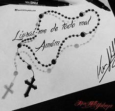 a cross and rosary on top of a piece of paper next to a pen with writing underneath it