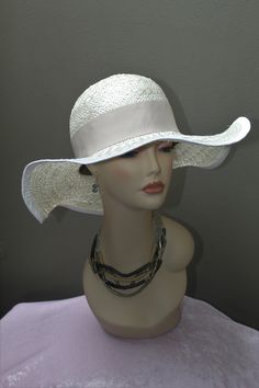 Hand made women's Sisal Sun hat by Alexander & Hallatt in white with beige band. Great feel and movement of pure sisal. Crown is stiffened. Please note that Alexander & Hallatt strive to produce the highest quality hats with minimal synthetic materials (synthetics used in mass produced hats flooding the market). With care, this hat can last a long time. Also note that there will be imperfections, like a stich showing or a line which is not perfect, but this adds to the charm of a true one-of a k Classic White Boater Hat With Curved Brim, White Toquilla Straw Hat Bands For Vacation, White Short Brim Straw Panama Hat, White Straw Panama Hat With Short Brim, Fitted Flat Brim Sun Hat For The Beach, Classic Cream Straw Hat For Beach, Fitted Sun Hat With Upf 50+ For The Beach, Fitted Flat Brim Sun Hat For Beach, White Straw Panama Hat With Flat Brim