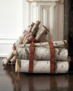 a pile of logs sitting on top of a wooden floor