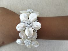 Handmade bracelet with 3 flowers of white mother of pearl, white glass crystal, white beads or a flower of black lava, 2 flowers of white moonstone, black glass crystal, black beads. All bracelets are nickel free, anti-allergenic. Measurements: Flower width is 1.37 in / 3.5 cm. It is a semi flexible and open bangle fit for medium to small sized wrists. It is a good fit for you if your wrist measures from 5.5 in to 6.2 in / 14cm -16 cm in circumference as measured with a flexible tape measure.  W Handmade White Pearl Bracelet With Flower Shape, Handmade White Pearl Flower Bracelet, Handmade White Flower Pearl Bracelet, Adjustable Mother Of Pearl Bracelets For Weddings, Adjustable Mother Of Pearl Wedding Bracelets, White Mother Of Pearl Bracelets For Wedding, Adjustable Pearl White Flower-shaped Jewelry, White Mother Of Pearl Bracelet For Wedding, White Flower-shaped Mother Of Pearl Jewelry