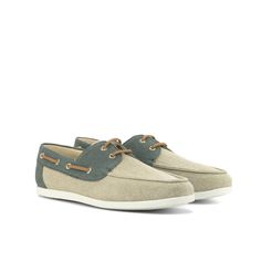 a pair of men's boat shoes in grey and tan sued with white soles