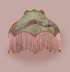 an umbrella with fringes on it and a bird painted on the inside of it