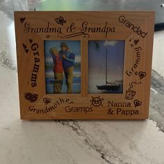 a wooden frame with two pictures and hearts on the front that says grandma & grandpa