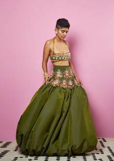 A military green taffeta bralette embellished in our signature 3D embroidery with metal collars, pearls, and stones, with a chain-link strap.Signature Papa Don't Preach silhouette featuring a millitary green Taffeta balloon lehenga with embellished yoke in acrylics, metal collars, pearls sequin and glass beads.From Papa Don’t Preach’s Zsa Zsa Zsu collection. DELIVERY TIMEPlease allow 8-12 weeks for your outfit to arrive. FABRIC DETAILSTafetta. Professional cleaning only. Glamorous Green Embellished Choli, Glamorous Green Choli For Wedding, Glamorous Green Wedding Choli, Festive Green Glamorous Choli, Glamorous Green Lehenga For Party, Glamorous Green Choli For Festive Season, Glamorous Green Choli For Festive Occasions, Embellished Green Organza Lehenga, Glamorous Festive Green Choli