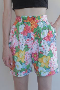 Cool Kenzo Paris multi colored floral printed high waisted shorts. Perfect 80's high fashion street wear. Fabric is a medium weight cotton. Shorts have pleats in the front, darts at the waist in back. Side front pockets. Cuff at the shorts hem. Front plastic zipper with button at the waist. Label Kenzo Paris, Size 38, 100% cotton, wash cold, hang dry. Very good vintage condition with no fabric or sewing flaws. Measurements Waist 62cm/ 24.5inches Hips 102cm/ 40inches Waist to hem 44cm/ 17inches M Retro Floral Print Bottoms For Spring, Retro Printed Bottoms For Spring, Retro Cotton Shorts For Spring, Retro Summer Floral Print Bottoms, Retro Floral Print Summer Bottoms, Fitted Floral Print Shorts, Retro High-waisted Shorts For Summer, Retro Shorts For Spring, Multicolor Floral Print Cotton Shorts