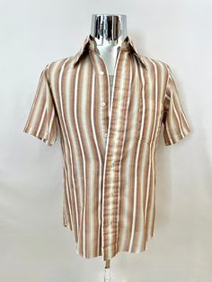 "Vintage 60's H.I.S. Mod, Brown, Striped, Short Sleeve, Shirt (S) This Men's Shirt comes in white polyester/cotton blend with a striped print in brown, yellow, white and blue with short sleeves, front button closure, a single chest pocket and butterfly collar. *The fabric is soft, light weight, without stretch and has a matte surface. Cotton Polyester Made in USA *This Shirt is in excellent condition with a faint mark on the bottom left side (photo #10) *Free shipping within the US. Size: (S) Chest: 40\" Sleeve Length: 10\" (outside) and 6\" (inside) Length: 28 1/2\" (front) 30\" (back)  Shoulder to Shoulder: 16\" Weight: 5 oz *Follow FreshandSwanky on Instagram" Retro Fitted Camp Shirt For Spring, White Fitted Camp Shirt For Spring, Fitted White Camp Shirt For Spring, Retro Fitted Collared Camp Shirt, Fitted Retro Collared Camp Shirt, Fitted Collared Retro Camp Shirt, Retro Fitted Shirt For Summer, Retro Fitted Summer Shirt, Retro Summer Shirt With Spread Collar