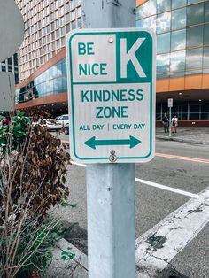 a green and white sign that says be nice, kindness zone all day every day