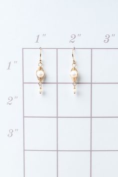 A beautiful gift for those born in June, featuring their birthstone of stunning pearl that is hand wrapped in a gold filled herringbone weave. These feminine earrings dangle from gold filled earwires. Gold Filled (lead and nickel free) Pearl 1.25", on gold filled earwires We hand select our natural materials, thus there may be slight variations in color and/or size that will not detract from the overall aesthetic Our unique handcrafted designer jewelry for women is made in America, with each des Nickel-free 14k Gold-filled Pearl Earrings, Gold Wire Wrapped 14k Gold Filled Pearl Earrings, Gold 14k Gold Pearl Earrings With Ear Wire, Gold Pearl Earrings With 14k Ear Wire, Gold Pearl Jewelry Wire Wrapped, 14k Gold Filled Nickel-free Pearl Earrings For Gift, 14k Gold Filled Nickel Free Pearl Earrings For Gift, Gift 14k Gold Filled Nickel-free Pearl Earrings, Gift 14k Gold Filled Pearl Earrings With Ear Wire