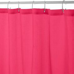 a pink shower curtain hanging on a metal rod