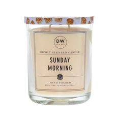 a candle that is sitting on a white surface with the words sunday morning printed on it