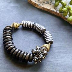 Such a chic bracelet by @aishalikesit! ✨ The darker tones paired with the brass accents are just gorgeous. 💙 #TheBeadChest #Bracelets #GooseBerryBeads #Beads #JewelryDesigner #DIYCrafts #KroboBeads #ArtisanBeads #MetalJewelry #AishaLikesIt Adjustable Bronze Jewelry With Polished Beads, Hand-strung Metal Bracelets With Round Beads, Bronze Jewelry With Large Beads, Large Metal Beads For Jewelry Making, Brass Beaded Bracelets With Round Beads, Spiritual Metal Beaded Bracelets With Round Beads, Spiritual Metal Beaded Bracelets, Silver Metal Round Beads, Hand-strung Brass Bracelets With Round Beads