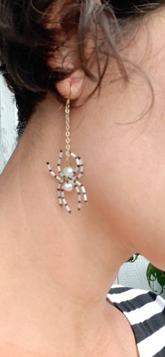 the back of a woman's neck wearing earrings