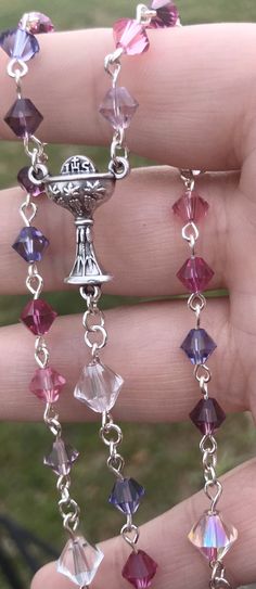 "This pink and purple color rosary would be a wonderful edition as a gift for your little girls First Communion. I used clear as the \"Our Father\" beads to help bring it all together. Perfect for the girl in your life. The rosary is made from 53 6mm and 6 8mm Preciosa Bicone Crystals. Loop and attached with head pins, and 4mm jump ring. The crucifix and First Communion medal are both lead and nickel free antique silver alloy metals. If you would like to check out our other rosary beads and jewe Handmade Spiritual Purple Rosary Bracelet, Purple Rosary, Pink Rosary, Rosary Gift, First Communion Gifts, Catholic Rosary, Communion Gifts, The Rosary, Our Father