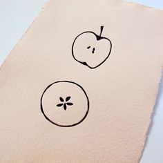 two apples drawn on top of a piece of paper