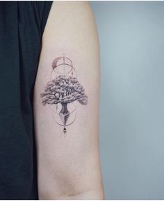 a tattoo on the arm of a man with a tree and moon in it,