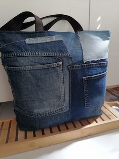 a bag made out of jeans sitting on top of a wooden shelf